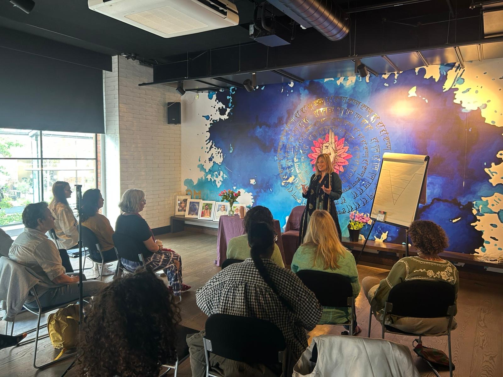 Gayatri leading a Satsang gathering with seated participants