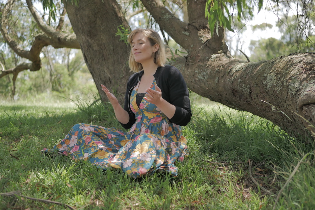 Gayatri meditating beneath a tree
