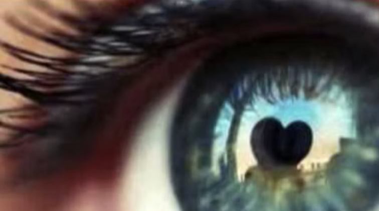Close-up of an eye with a heart reflected in it